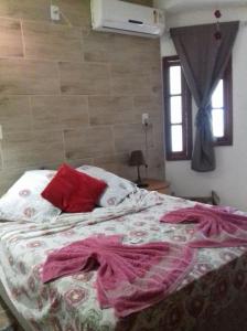 A bed or beds in a room at Pousada da Lu em Pelotas