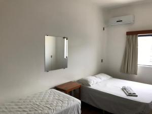 Een bed of bedden in een kamer bij Central Plaza Hotel Tupa