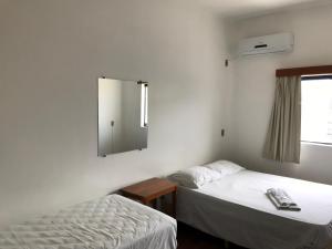 Ένα ή περισσότερα κρεβάτια σε δωμάτιο στο Central Plaza Hotel Tupa