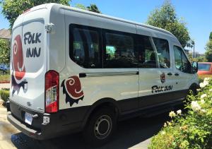 
a bus is parked on the side of the road at Folk Inn Ontario Airport in Ontario
