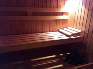 a wooden bench in a sauna with the light on at Villa Holiday in Karlovy Vary