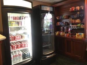 a refrigerator with its door open in a store at Folk Inn Ontario Airport in Ontario