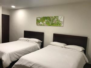 Postel nebo postele na pokoji v ubytování Hotel Plaza