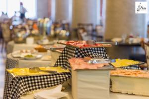 a buffet line with plates of food on a table at Hotel Panamericano in Santiago