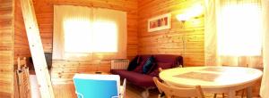 a wooden room with a table and a chair at La Albarina in Galende