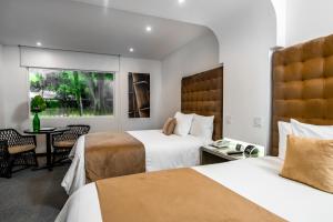 Ein Bett oder Betten in einem Zimmer der Unterkunft Riande Aeropuerto Hotel Casino