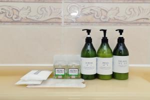 a group of three bottles of wine sitting on a counter at Suncheon Nobless Hotel in Suncheon