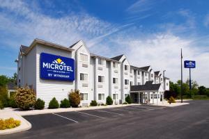 a hotel with a sign on the side of a building at Microtel Inn & Suites by Wyndham Hagerstown by I-81 in Hagerstown