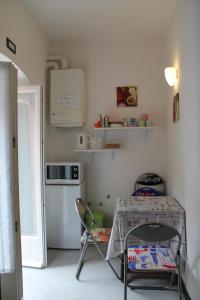 a small kitchen with a table and a refrigerator at "la Luna" in Vernazza