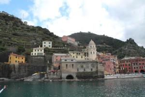 a group of buildings on a hill next to the water at "la Luna" in Vernazza