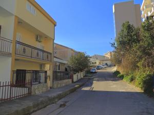 an empty street in a residential neighborhood with buildings at Guest House Jelena in Budva