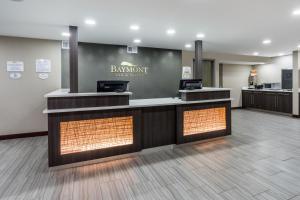 a hotel lobby with a sign on the wall at Baymont by Wyndham Clarksville in Clarksville