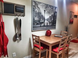 a dining room table with two chairs and a picture on the wall at Cozy 2-Bedroom Apartment #25 by Amazing Property Rentals in Gatineau