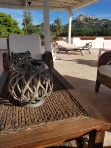 a wicker chair sitting on a patio with a table at Àstanza in Castellabate