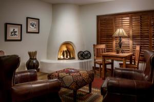 sala de estar con chimenea, mesa y sillas en The Hermosa Inn, en Phoenix