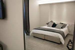 a bedroom with a bed and a mirror at Palazzo Margherita in Andria