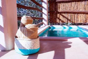 a basket is sitting next to a swimming pool at Casa Mono in San Agustinillo