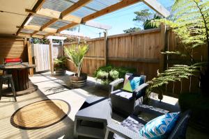 a patio with chairs and a table and a fence at Modern Wall in Cambridge