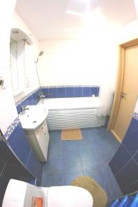 a small bathroom with a sink and a toilet at Studio in the center VLKSM 13 in Tyumen