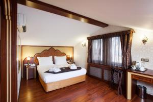 a bedroom with a large bed and a window at Ottoman Hotel Imperial-Special Category in Istanbul