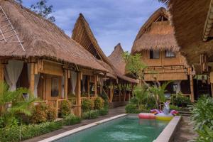 un complejo con piscina frente a un edificio en Moon Bamboo, en Canggu