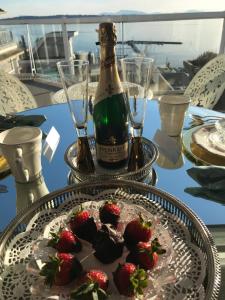 a bottle of champagne and strawberries on a table at Donna's Bed & Breakfast in White Rock