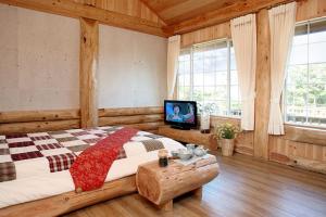 מיטה או מיטות בחדר ב-Jeju Bille Log Pension