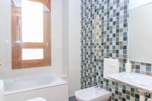 a white bathroom with a sink and a toilet at BET Apartments - Tramontana Apartments in Valencia