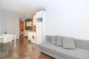 a living room with a couch and a table and a kitchen at BET Apartments - Tramontana Apartments in Valencia