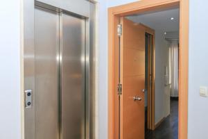 a hallway with a closet and a door with a mirror at BET Apartments - Tramontana Apartments in Valencia