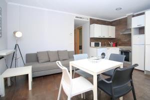 a kitchen and a living room with a table and chairs at BET Apartments - Tramontana Apartments in Valencia