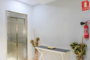 a room with a table and a fire extinguisher on the wall at BET Apartments - Tramontana Apartments in Valencia