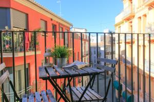 a wooden table on a balcony with a plant on it at BET Apartments - Tramontana Apartments in Valencia