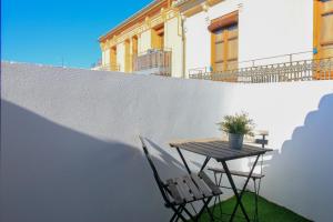 a table and chairs next to a white wall at BET Apartments - Tramontana Apartments in Valencia