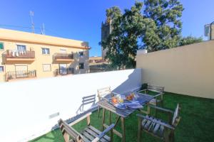 a table and chairs on the roof of a building at BET Apartments - Tramontana Apartments in Valencia