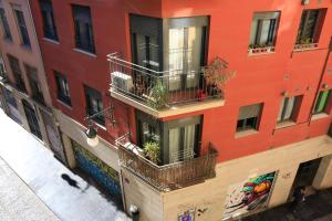 a red building with balconies and plants on it at BET Apartments - Tramontana Apartments in Valencia