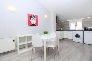 a kitchen with a white table and chairs in a room at BET Apartments - Tramontana Apartments in Valencia