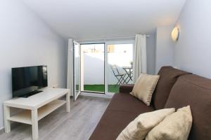 a living room with a couch and a television at BET Apartments - Tramontana Apartments in Valencia