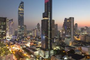 a city skyline at night with tall buildings at Amara Bangkok Hotel in Bangkok