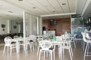 a large room with tables, chairs, and tables in it at Camping Lo Monte in Pilar de la Horadada