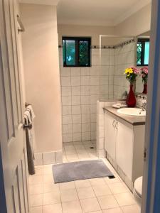 
a bathroom with a sink, toilet, and bathtub at Little Shangri-La B&B in Busselton
