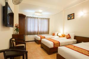 Postel nebo postele na pokoji v ubytování Ngoc Minh Hotel