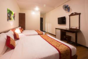 Postel nebo postele na pokoji v ubytování Ngoc Minh Hotel + 37 fotografií