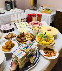 una mesa con muchos tipos diferentes de comida en ella en Black Sea Guest House, en Adler