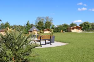 a bench in a park with houses in the background at Domaine De Soignolles in Soignolles