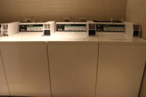 a row of four machines sitting on a counter at Hotel Midtown Richardson in Taipei +106 photos