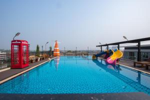 a swimming pool with a slide and a playground at B-your home Hotel Donmueang Airport Bangkok -SHA Certified SHA Plus in Bangkok