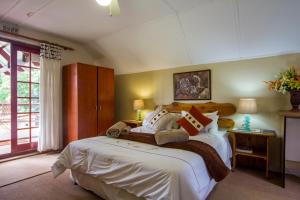 a bedroom with a large bed with white sheets at 40 Fraser Street Bed and Breakfast in Howick