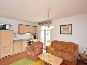 a living room with a couch and a table at Ferienwohnung-1a-7 in Baabe