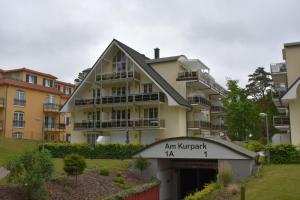 an apartment building with a garage in front of it at Ferienwohnung-1a-7 in Baabe